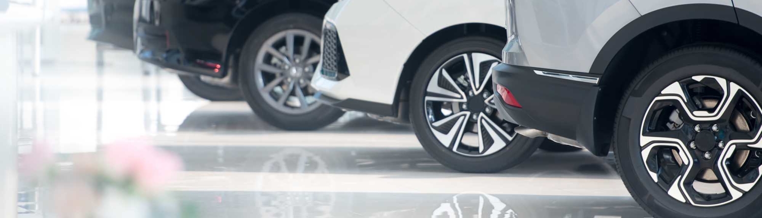 new vehicles on shiny car dealership flooring